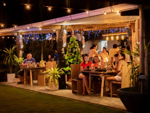 Bar and restaurant shot showing alresco night dining at Lokal Hotels Dauin