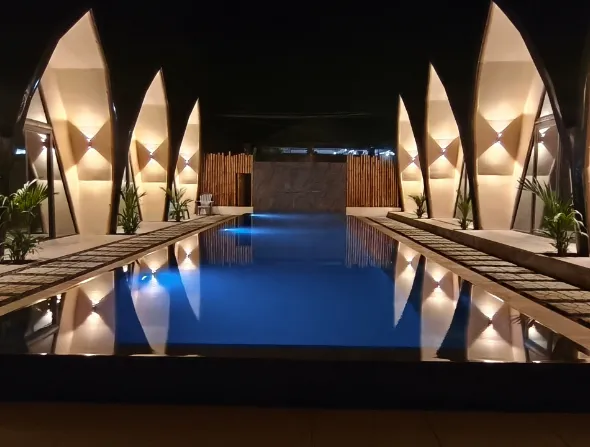 Pool and Rooms Exterior Night View at Lokal Hotels Dauin