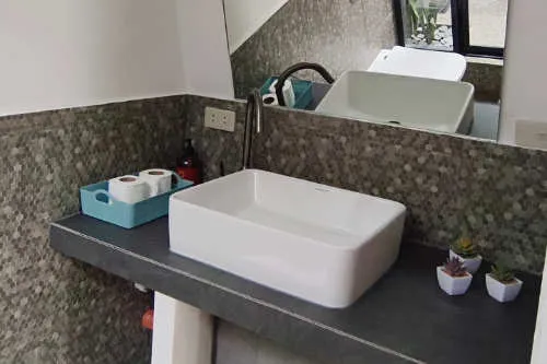 Bathroom Sink and Mirror in Poolside Room at Lokal Hotels Dauin